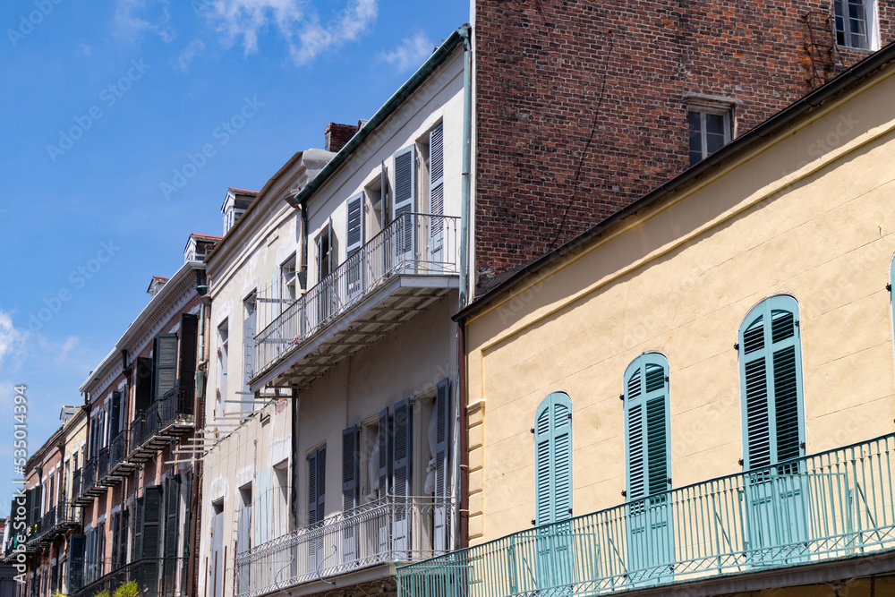 Naklejka premium Row of Colorful and Beautiful Old Buildings with Balconies in the French Quarter of New Orleans