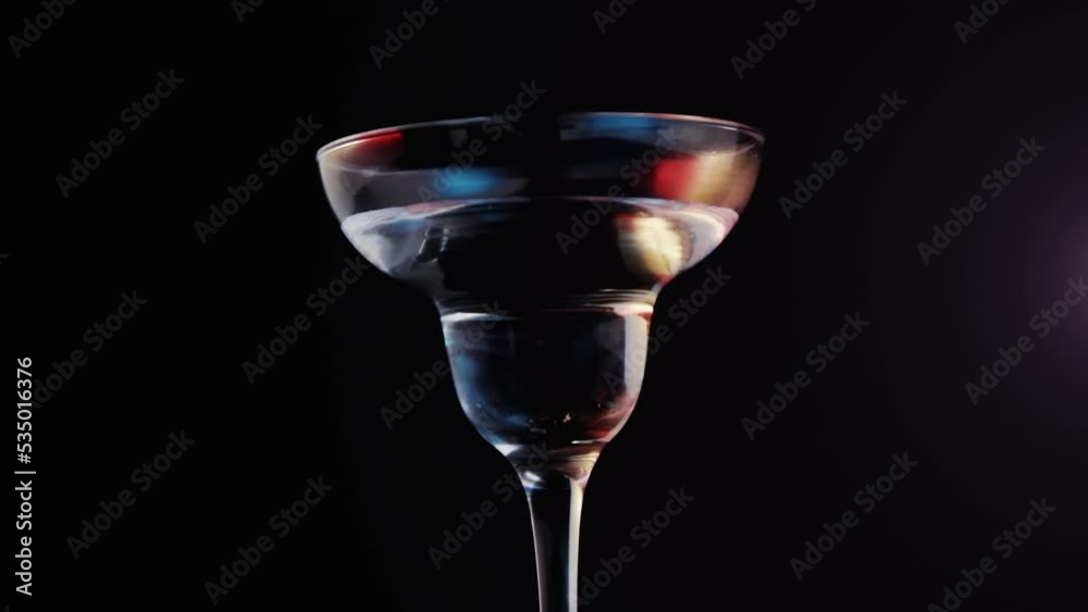 Animation of purple shapes over drink with olives on black background Animation of purple shapes over drink with olives on black background