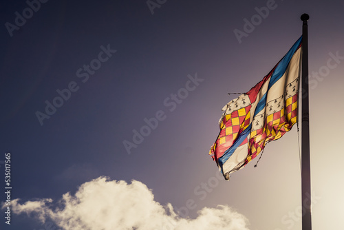 Colourful Flag against a blue sky photo