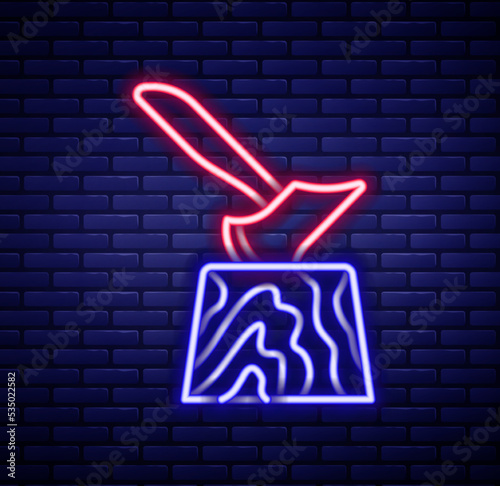 Glowing neon line Wooden axe in stump icon isolated on brick wall background. Lumberjack axe. Axe stuck in wood. Chopping wood. Colorful outline concept. Vector