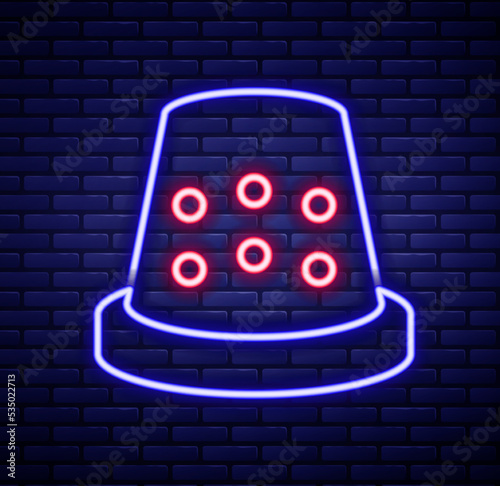 Glowing neon line Thimble for sewing icon isolated on brick wall background. Colorful outline concept. Vector