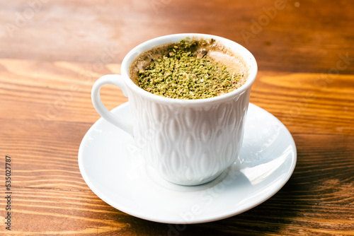 Pistachio coffee in a white cup. Turkish coffee with pistachio.