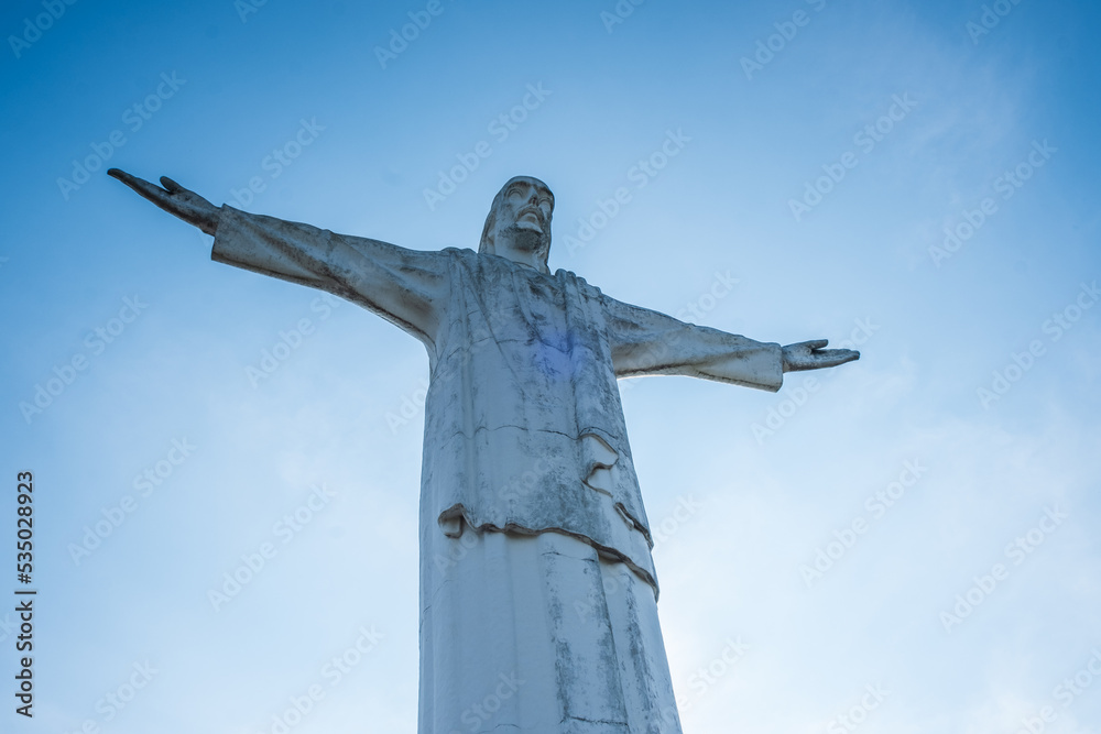 Cali, Colombia - April 20 2021: Cristo Rey (Christ the King) 26 metre statue located in the Cerro de los Cristales (Hill of the Crystals) in the village of Los Andes, west of the city of Cali