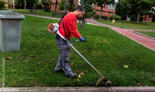 Gardener operating the weed cutter