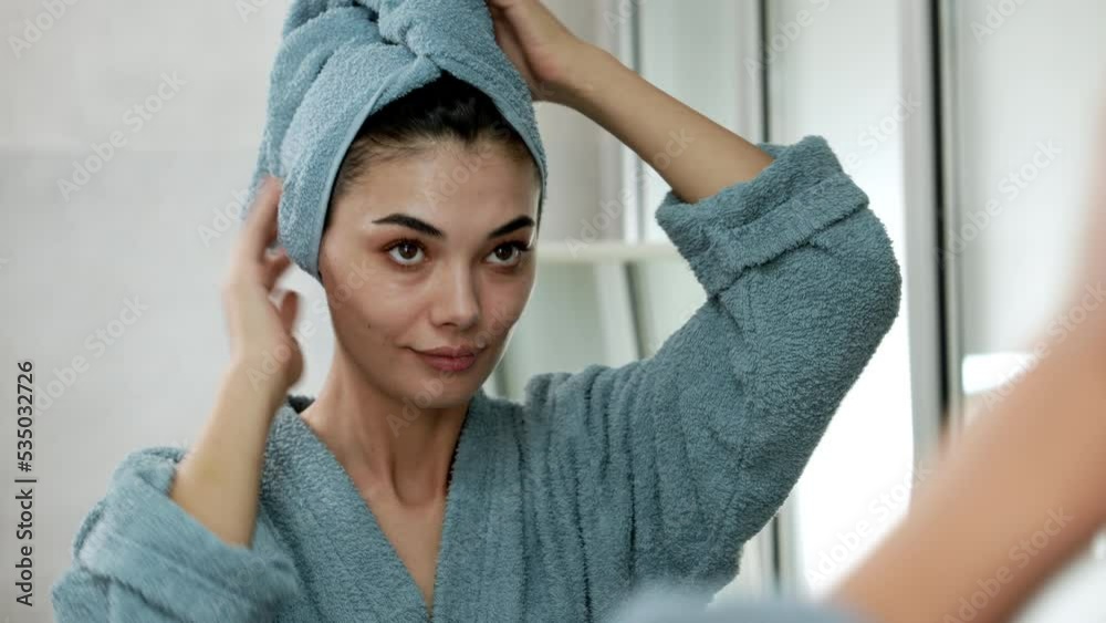 Reflection in a mirror beautiful woman making cosmetic skin care
