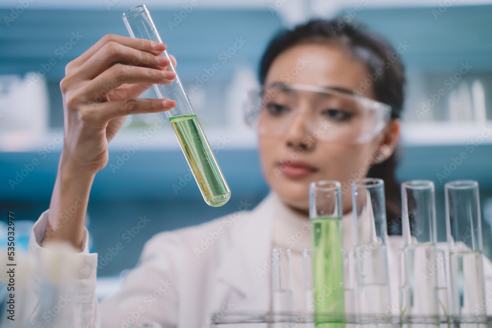 Researcher woman are looking to simple substance in tube on her hands at cosmetic lab and laboratory Researcher woman are looking to simple substance in tube on her hands at cosmetic lab and laboratory