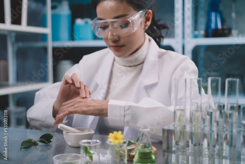 A young researcher is applying powdered research into his hands in the lab. women are happy to test cosmetics or medicine for beautiful skin care