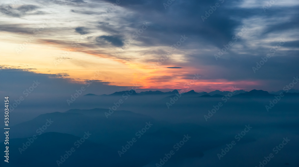 Canadian Mountain Landscape on the West Coast of Pacific Ocean. Dramatic Sunset and Hazy Smoky Sky. St. Mark's Summit near Vancouver, British Columbia, Canada. Nature Background