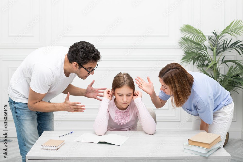 Young parents help their daughter with her lessons, but girl hate education and learn something Young parents help their daughter with her lessons, but girl hate education and learn something