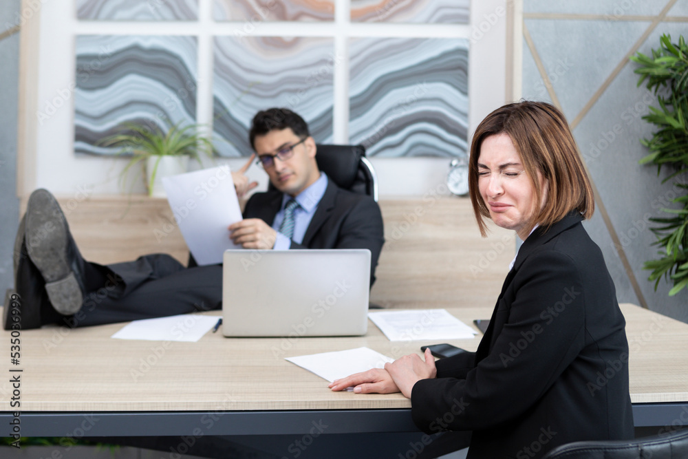 Frustrated female office worker crying because of her angry boss fired her and pointing to the door Frustrated female office worker crying because of her angry boss fired her and pointing to the door