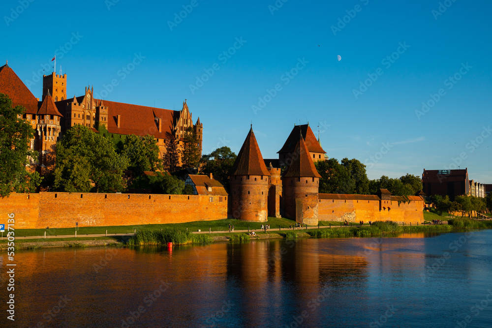 Marienburg Castle the largest medieval brick castle in the world in the city of Malbork at sunset
