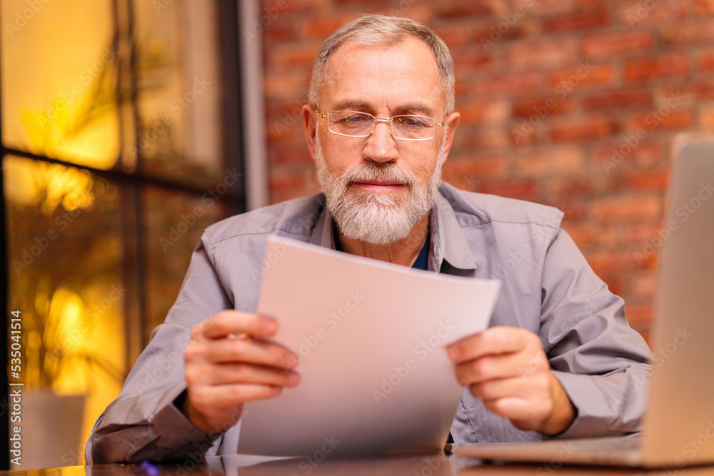 worried aged man sit by laptop and try do make payment online worried aged man sit by laptop and try do make payment online