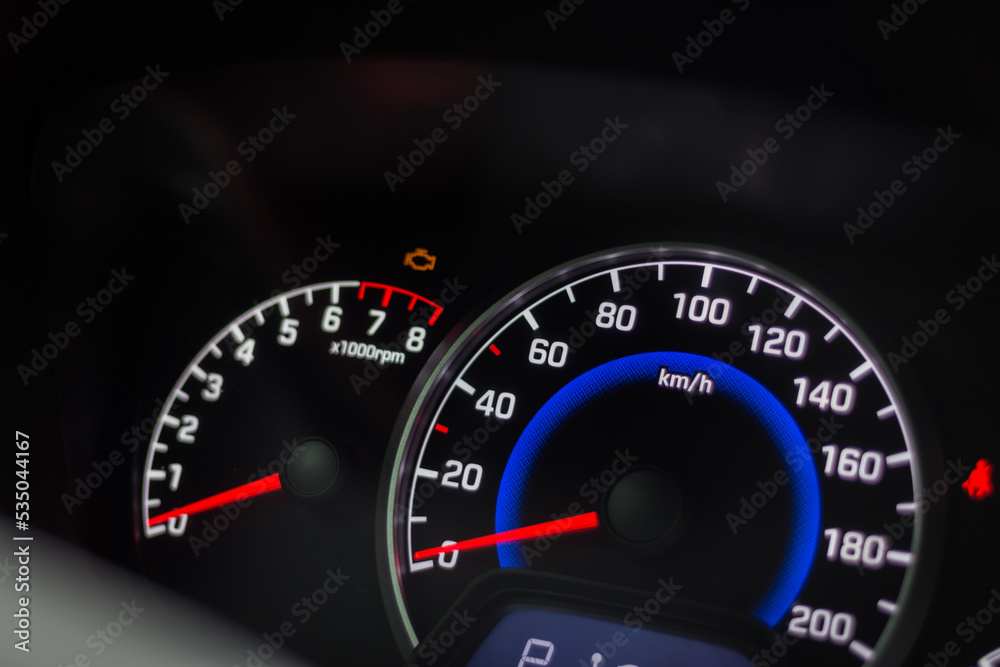 Modern car interior. Car dashboard. Engine system. Automobile speedometer. Modern transportation. Auto panel and steering wheel. Speed measure. Illuminated car dashboard.