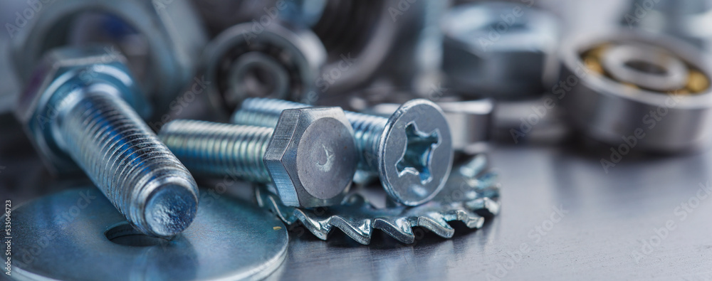 Fototapeta premium set of different nuts, bolts, screws, washers and drill bits,thread tap and mill cutters on steel plate background. Locksmithing deal.