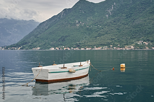 boats on the lake surrounded by mountains