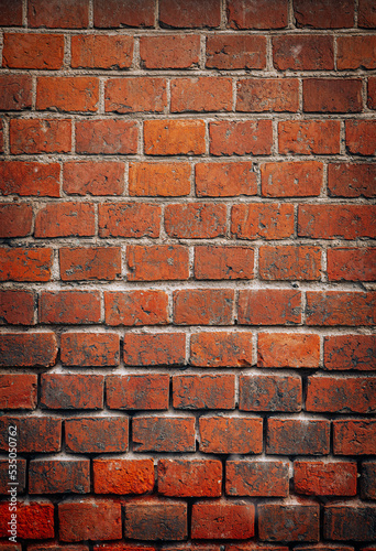 Beautiful vertical brick background of dark red bricks  old red brick masonry  with light vignette