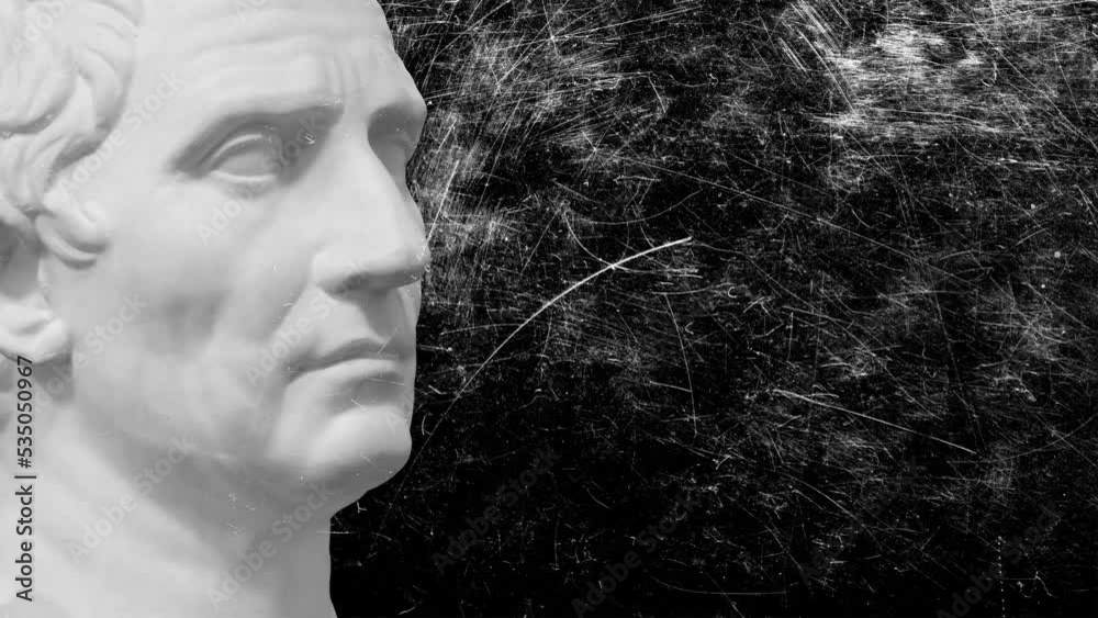 Greek sculpture of a man made of white stone with flashing white scratches on a black background