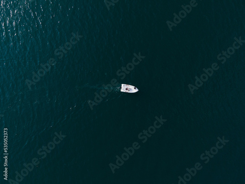 Single boat in the middle of the lake in the south switzerland in ticino with and no waves engine running and moving © andre