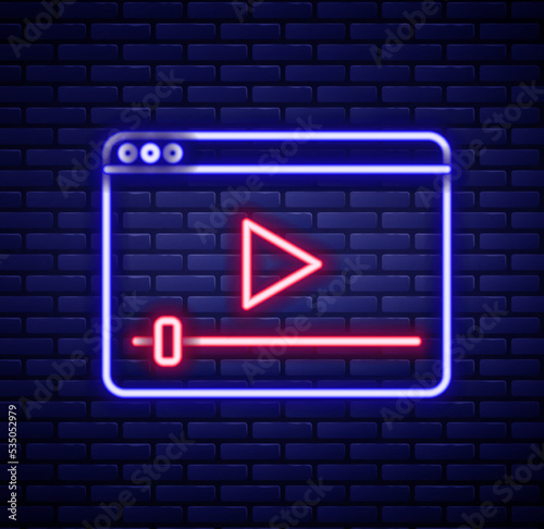 Glowing neon line Online play video icon isolated on brick wall background. Film strip with play sign. Colorful outline concept. Vector photo