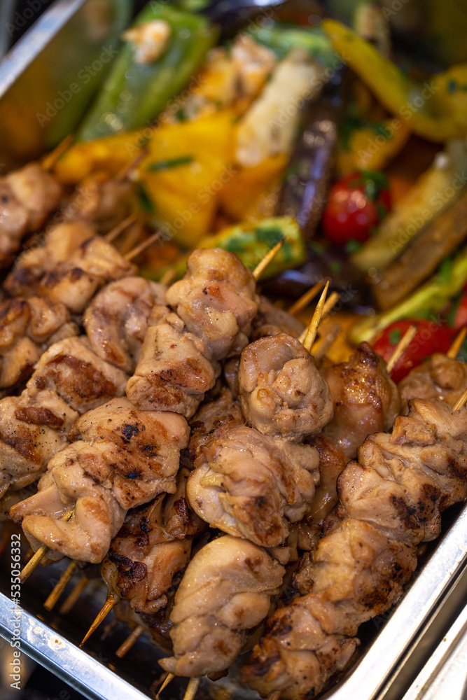 chicken kebab on a wooden stick in marmite top view chicken kebab on a wooden stick in marmite top view