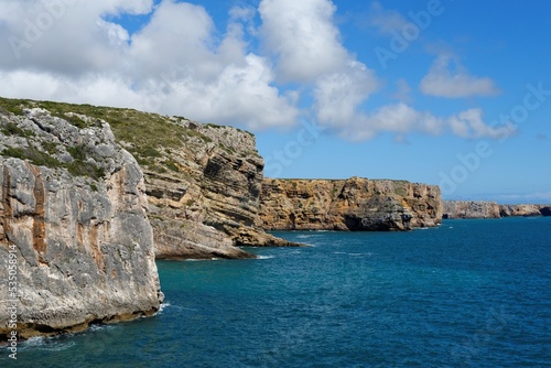 Scenic rocks on Atlantic coast near Cabo de Sao Vicente Cape in the Algarve, Portugal, on bright summer day