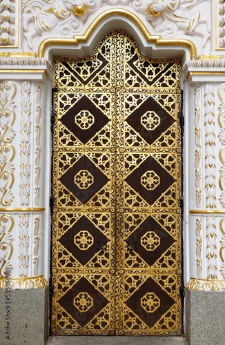 Ornamented gilded door of the Dormition cathedral of Kyiv Pechersk Lavra (Kiev Monastery of the Caves) in Kiyv, Ukraine