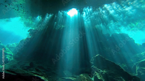 light beam from above, seen scuba diving in chac-mool cenote near cancun mexico photo