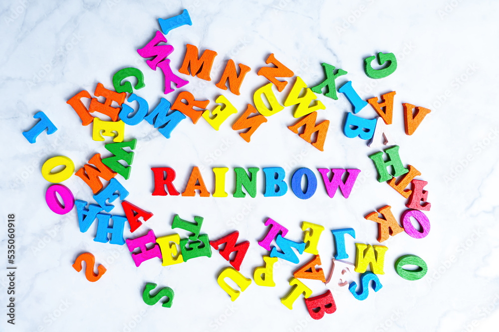 RAINBOW word made from multicolored wooden letters