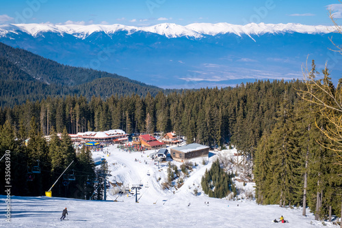 Winter landscape with panorama of Bansko above the clouds. Famous ski resort in Bulgaria. View of the ski slopes and the Pirin Mountains photo