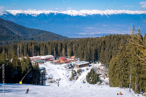 Winter landscape with panorama of Bansko above the clouds. Famous ski resort in Bulgaria. View of the ski slopes and the Pirin Mountains