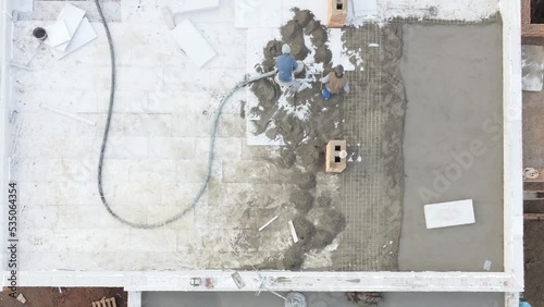 Roofing construction worker installing a flat roof. 
