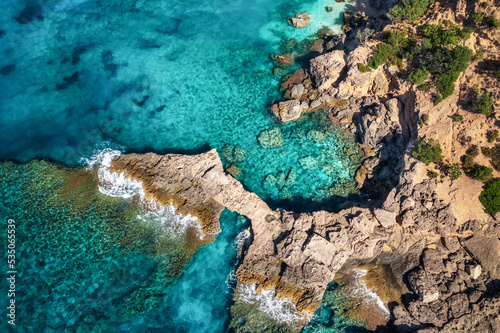 Beautiful summer seascape from air. Turquoise sea water with waves and rocks from top view, Islands of sardinia in Italy