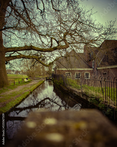 Canal with tree and house in the vintage style