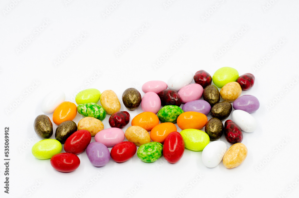 Colorful candy canes. Dragee chocolate candies isolated on white background.
Colorful candy canes. Dragee chocolate candies isolated on white background.