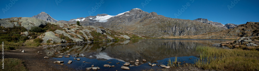 a beautiful panoramic view of the lac blanc with the highest summit of the Vanoise, the dent parrachee, in the distance