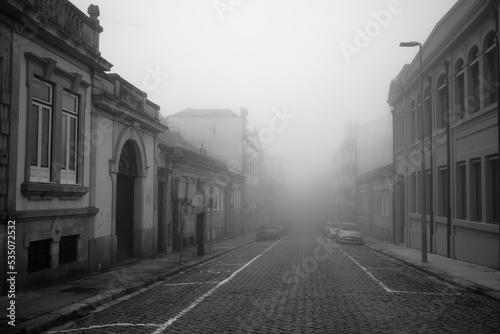 A street in the morning in thick fog. Porto, Portugal. Black and white photo.