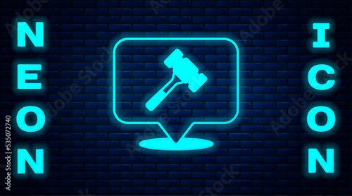 Glowing neon Auction hammer icon isolated on brick wall background. Gavel - hammer of judge or auctioneer. Bidding process, deal done. Auction bidding. Vector