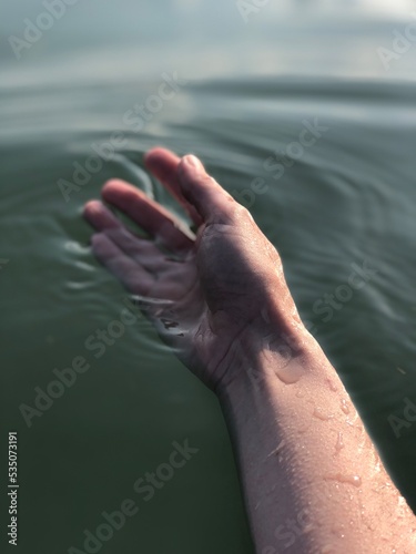 Woman's hand in water. Swimming and relaxation concept