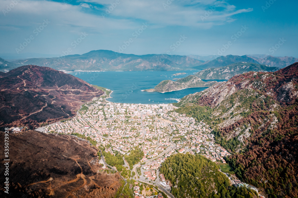 Aerial landscape with a view of Icmeler surrounded by mountains and forests. Forest after big fires in Turkey. View of the mediterranean bay near Marmaris