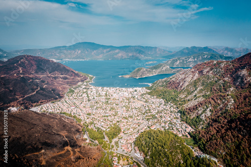 Aerial landscape with a view of Icmeler surrounded by mountains and forests. Forest after big fires in Turkey. View of the mediterranean bay near Marmaris
