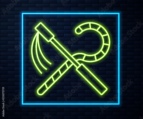 Glowing neon line Crook and flail icon isolated on brick wall background. Ancient Egypt symbol. Scepters of egypt. Vector