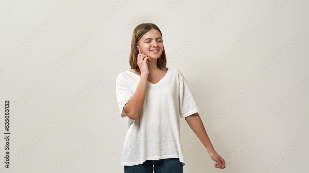 Pleased girl push on earphone for choose music Pleased girl push on earphone for choose music