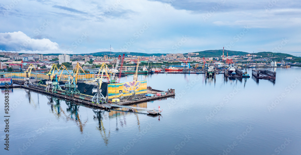 Murmansk, Russia - June 13, 2021: Panoramic aerial view of the port of Murmansk, ships and ship docks. Summer landscape in the north of Russia. Kola Bay of the Barents Sea