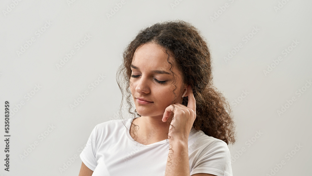 Girl push on wireless earphone for choose music Girl push on wireless earphone for choose music