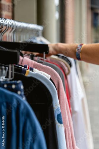 Woman Browsing Clothing Rack of Clothes