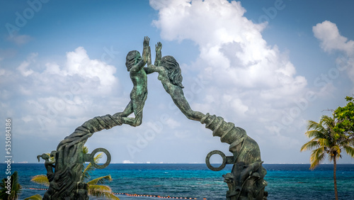 PLAYA DEL CARMEN, MEXICO - JULY. 27, 2021: Portal Maya sculpture in Fundadores Park beach at Playa del Carmen on the Caribbean coast of Riviera Maya photo