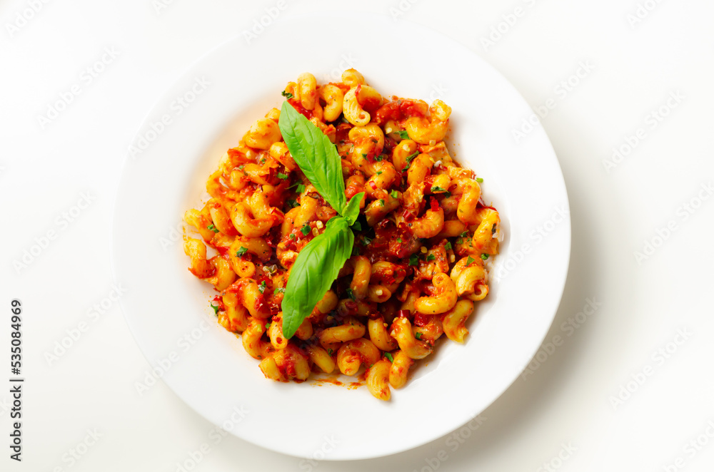 Cooked cellentani pasta with cooked chicken breast and peppers in a spicy tomato and jalapeno dressing Cooked cellentani pasta with cooked chicken breast and peppers in a spicy tomato and jalapeno dressing