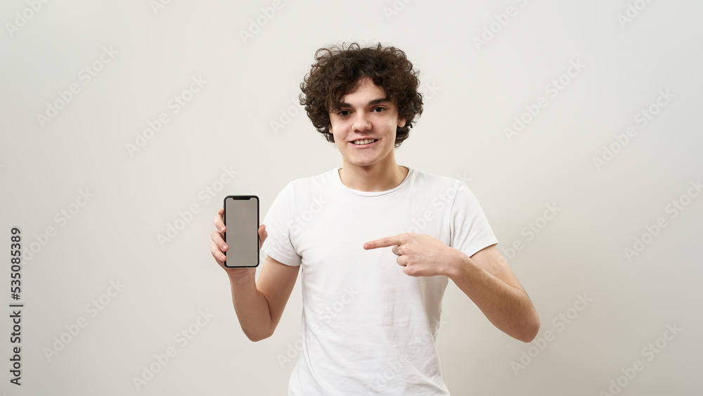 Smiling boy show smartphone and look at camera Smiling boy show smartphone and look at camera