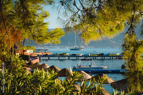 Summer landscape on the Mediterranean coast in Turkey near Marmaris and Icmeler. View of the bay and mountains through pine branches photo