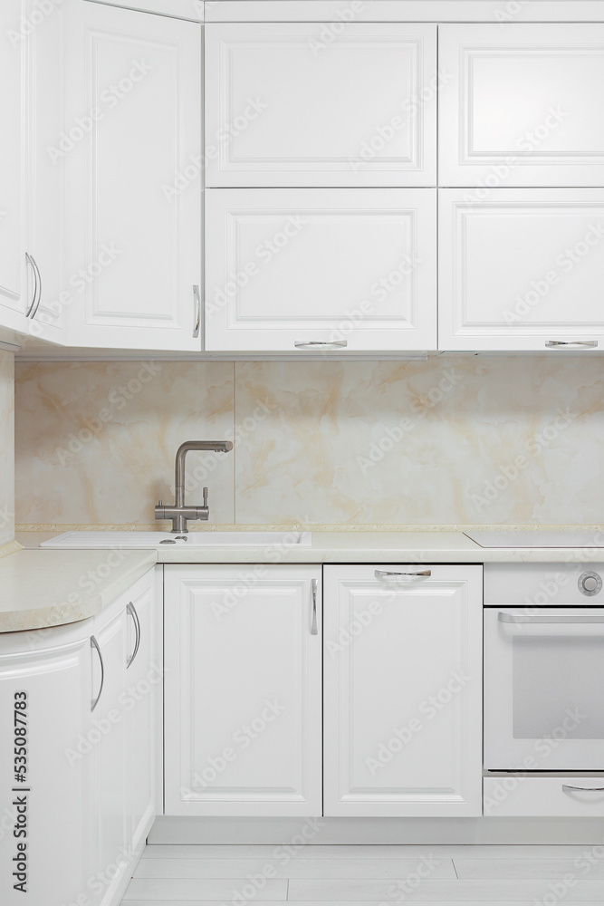 Fototapeta premium Facade of white kitchen furniture in the kitchen